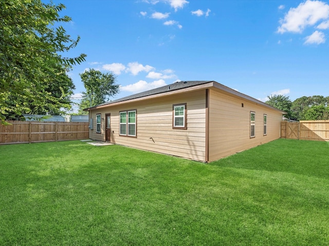 back of house with a lawn