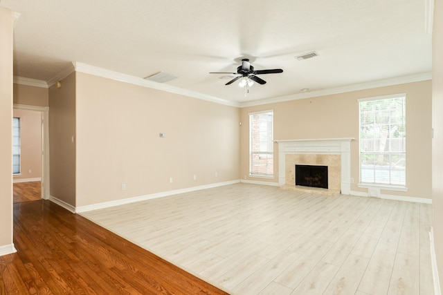 unfurnished living room with hardwood / wood-style flooring, ceiling fan, and ornamental molding