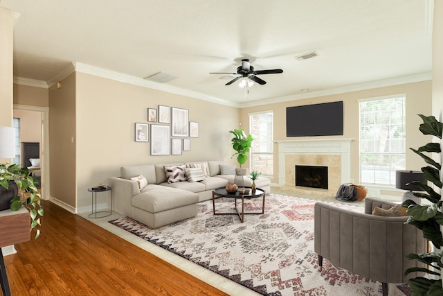 living room featuring crown molding, ceiling fan, and hardwood / wood-style flooring