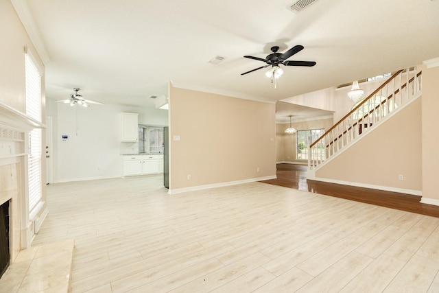 unfurnished living room featuring light hardwood / wood-style floors, ornamental molding, and a tiled fireplace