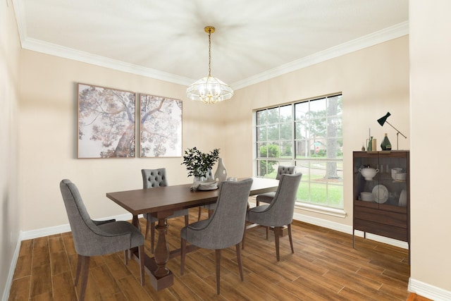 dining area with dark hardwood / wood-style floors, crown molding, and a notable chandelier