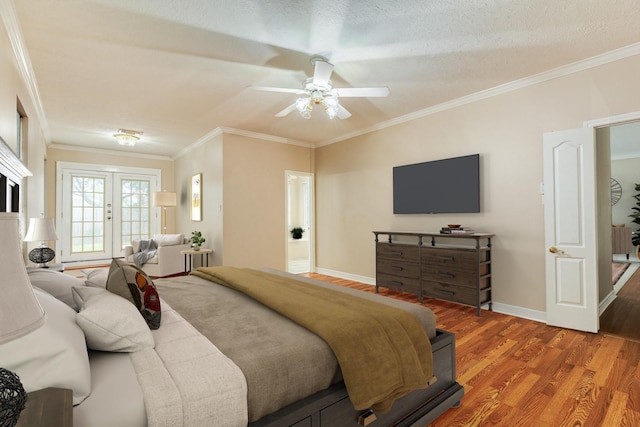 bedroom featuring hardwood / wood-style floors, ceiling fan, ornamental molding, and a textured ceiling