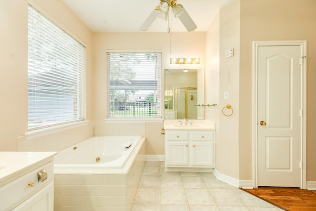 bathroom with tile patterned floors, ceiling fan, vanity, and separate shower and tub