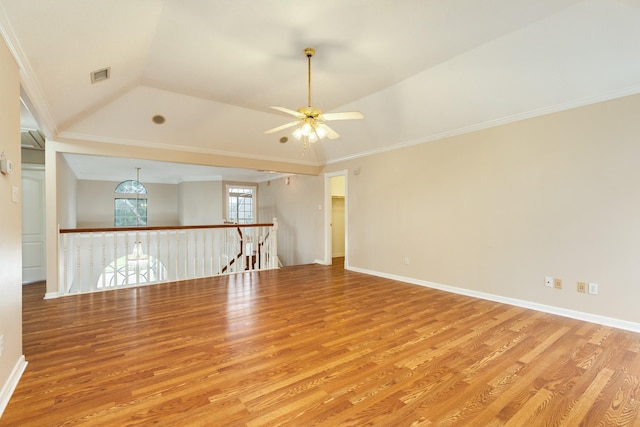 unfurnished room featuring ceiling fan with notable chandelier, ornamental molding, and light hardwood / wood-style flooring