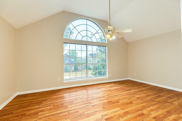 spare room with light hardwood / wood-style floors, ceiling fan, and lofted ceiling