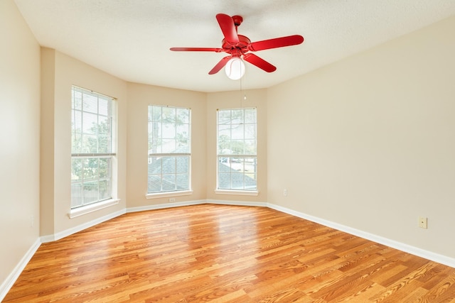 unfurnished room with a textured ceiling, light hardwood / wood-style flooring, and ceiling fan