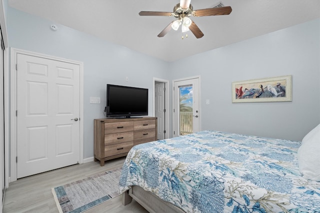 bedroom featuring access to exterior, light hardwood / wood-style floors, and ceiling fan