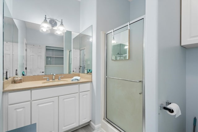 bathroom with vanity and a shower with shower door