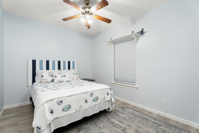 bedroom with hardwood / wood-style flooring and ceiling fan