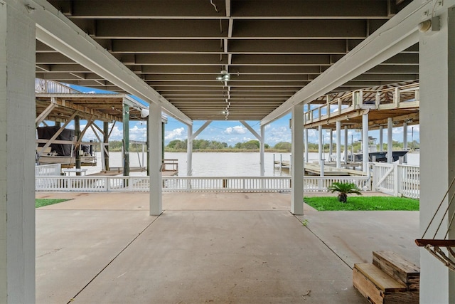 view of patio / terrace with a water view and a dock