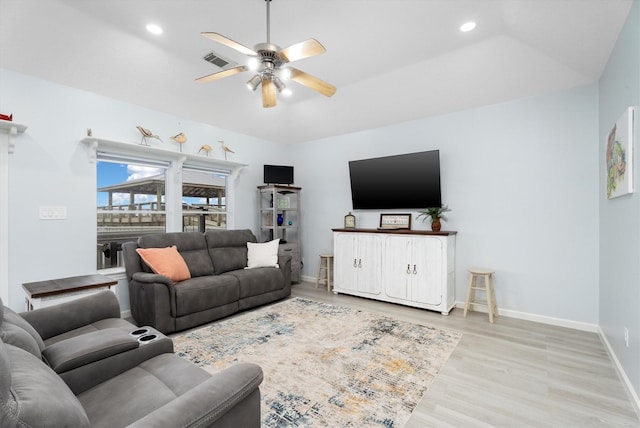 living room featuring ceiling fan, light hardwood / wood-style flooring, and lofted ceiling