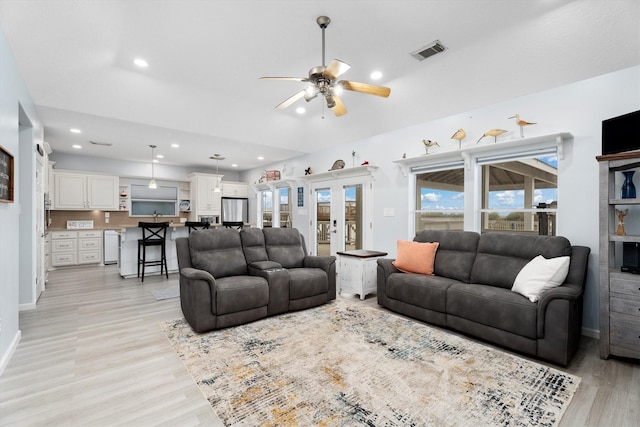 living room with ceiling fan, light wood-type flooring, and french doors