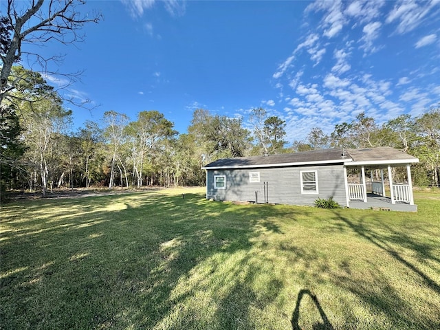 exterior space featuring a lawn and a porch