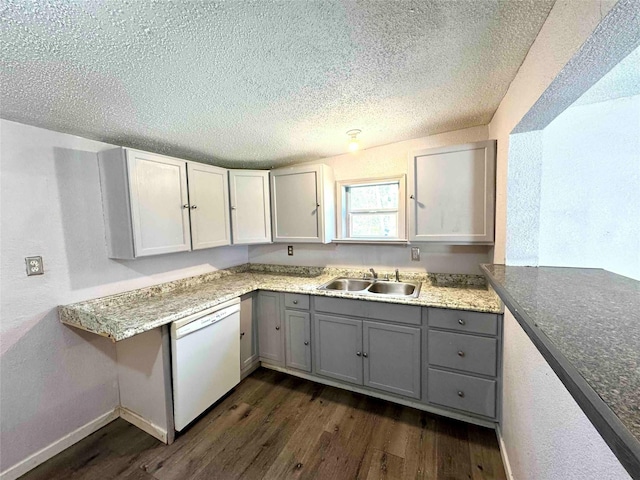 kitchen featuring gray cabinetry, dishwasher, sink, dark wood-type flooring, and a textured ceiling