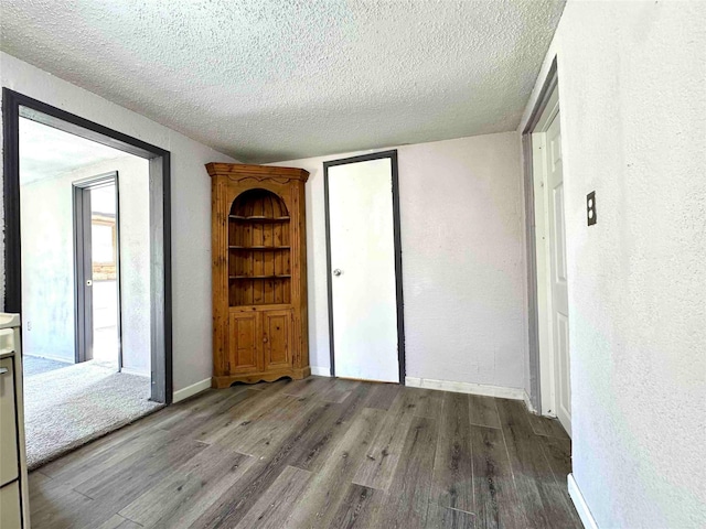 unfurnished bedroom with a textured ceiling and light hardwood / wood-style floors