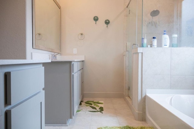 bathroom featuring tile patterned floors, vanity, and shower with separate bathtub