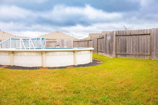 view of yard with a fenced in pool