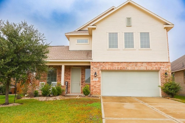 view of front of house with a front yard and a garage