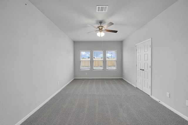 spare room featuring carpet flooring and ceiling fan