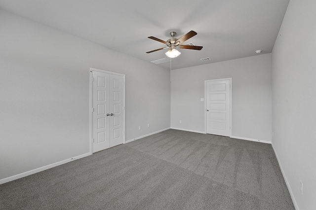 carpeted spare room featuring ceiling fan