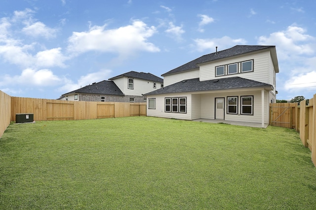 rear view of house with a lawn