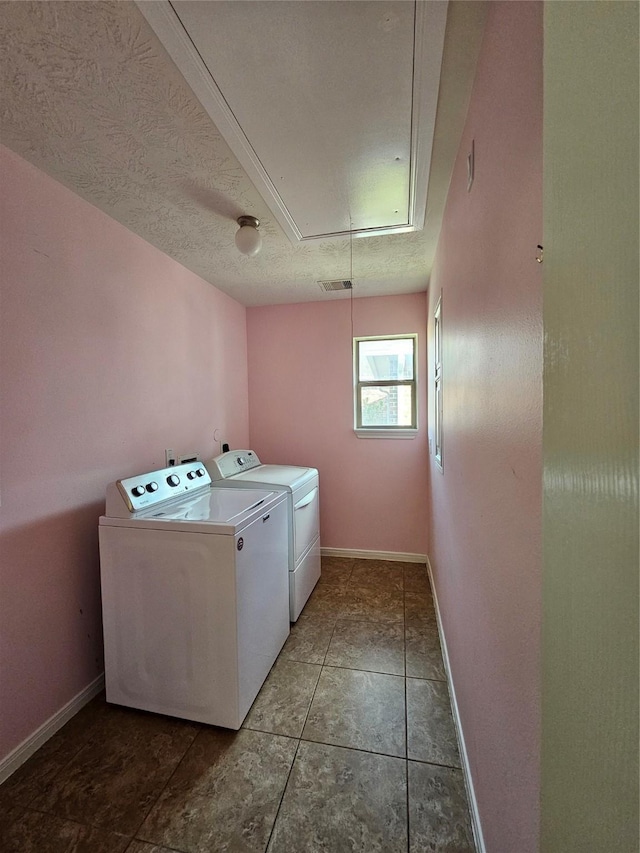 laundry room featuring tile patterned floors, a textured ceiling, and independent washer and dryer