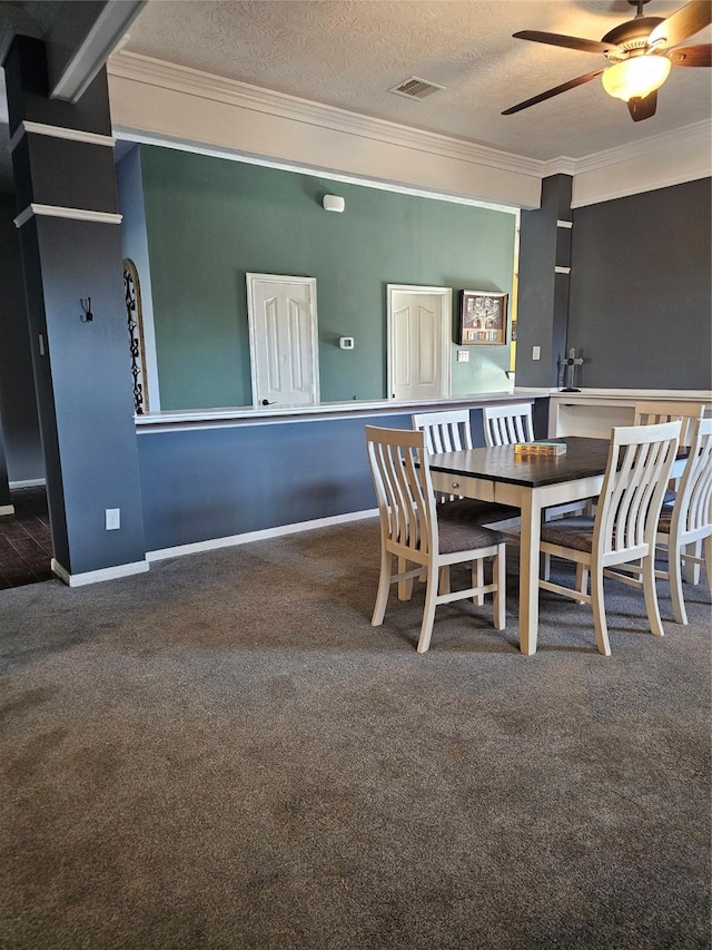 dining area with ceiling fan, carpet, a textured ceiling, and ornamental molding