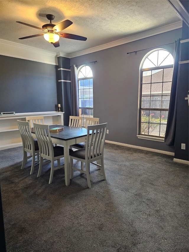 dining space featuring dark colored carpet, a textured ceiling, ceiling fan, and a healthy amount of sunlight