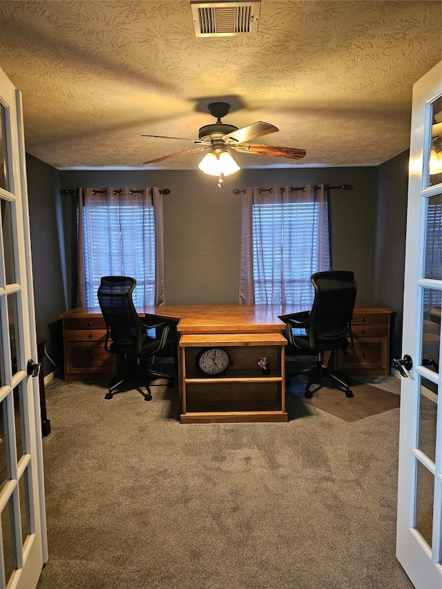 office space featuring carpet, french doors, and a textured ceiling