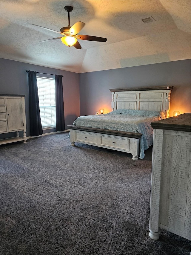 unfurnished bedroom with dark colored carpet, ceiling fan, lofted ceiling, and a textured ceiling