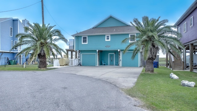 view of front of property featuring a front yard and a garage