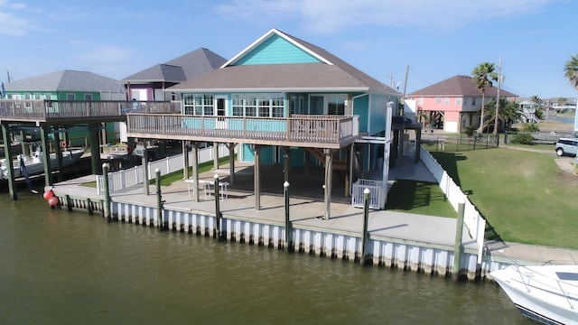 dock area with a lawn, cooling unit, a patio, and a deck with water view