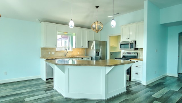 kitchen featuring appliances with stainless steel finishes, white cabinetry, hanging light fixtures, and a center island