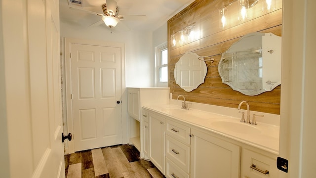 bathroom featuring hardwood / wood-style flooring, vanity, ceiling fan, and wooden walls