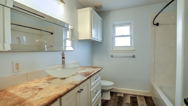 bathroom with toilet, hardwood / wood-style flooring, and vanity