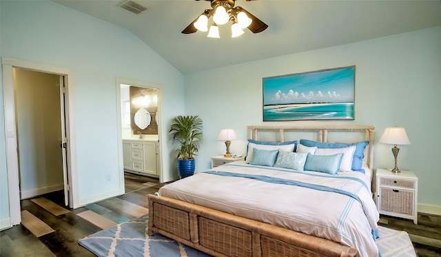 bedroom with ceiling fan, dark hardwood / wood-style flooring, lofted ceiling, and ensuite bath