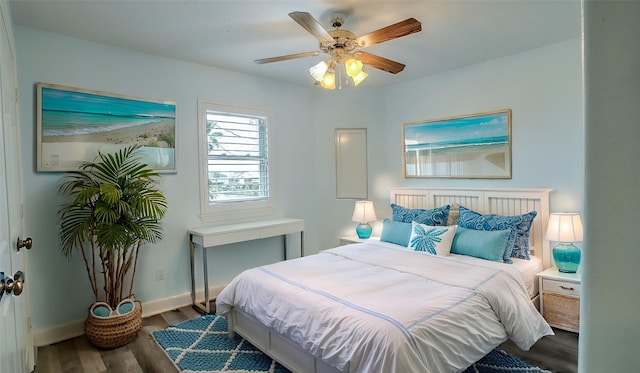 bedroom with ceiling fan and dark hardwood / wood-style flooring