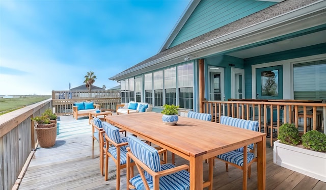 wooden terrace with an outdoor hangout area