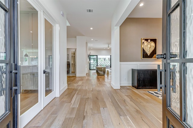 entryway featuring french doors and light hardwood / wood-style flooring