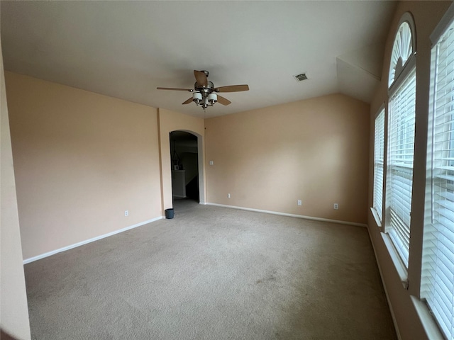 spare room featuring carpet flooring, ceiling fan, and vaulted ceiling