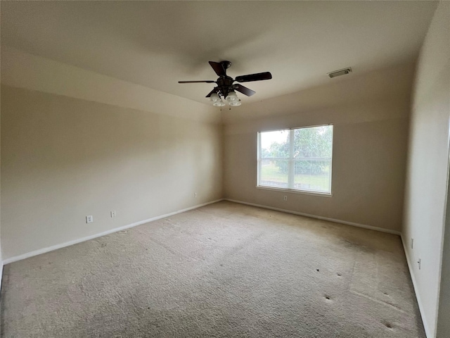 spare room with light carpet and ceiling fan