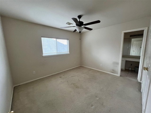 carpeted spare room with ceiling fan