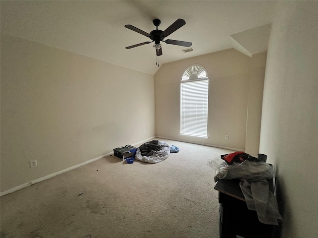 carpeted empty room featuring vaulted ceiling and ceiling fan