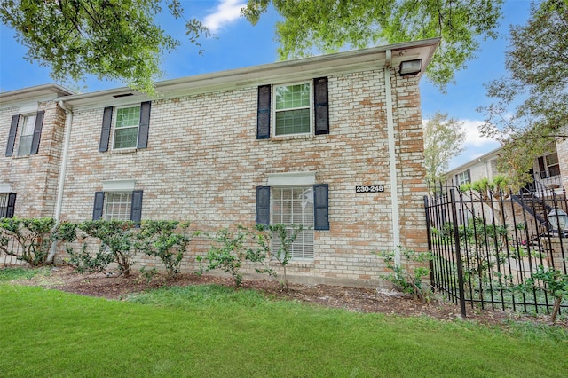 view of side of home with a yard