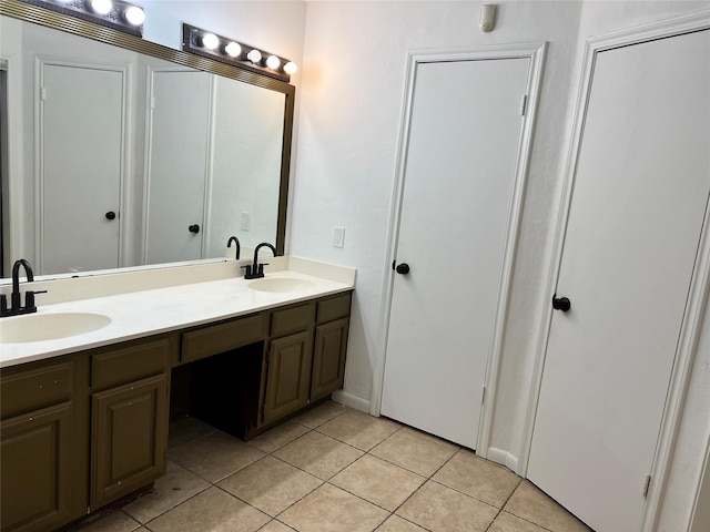 bathroom featuring tile patterned flooring and vanity