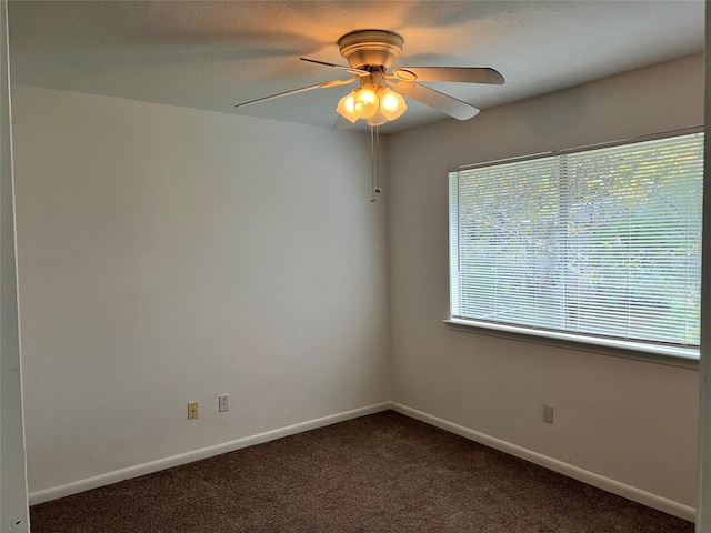 unfurnished room featuring ceiling fan and dark carpet