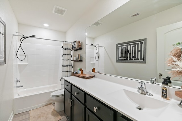 full bathroom with hardwood / wood-style floors, shower / bath combo, toilet, and vanity