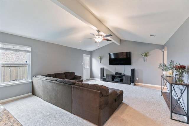 carpeted living room with vaulted ceiling with beams and ceiling fan