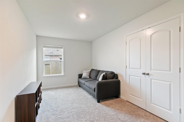 living area with light colored carpet