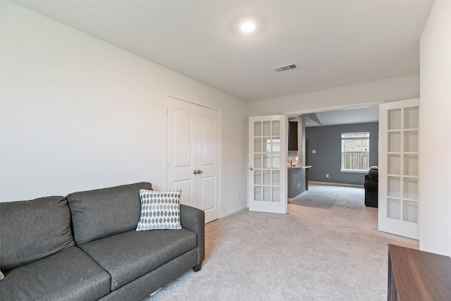 carpeted living room featuring french doors